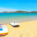 Surfboards on the golden beach of Porto Pollo