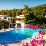 Pool view of Il Borgo of the Palmasera resort among the bougainvillea